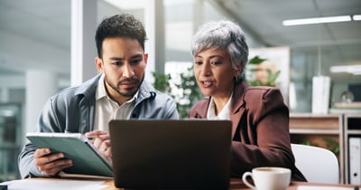  Two professionals considering EHRs on Laptop and Tablet