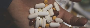 Hand holding pills, representing Fentanyl Crisis