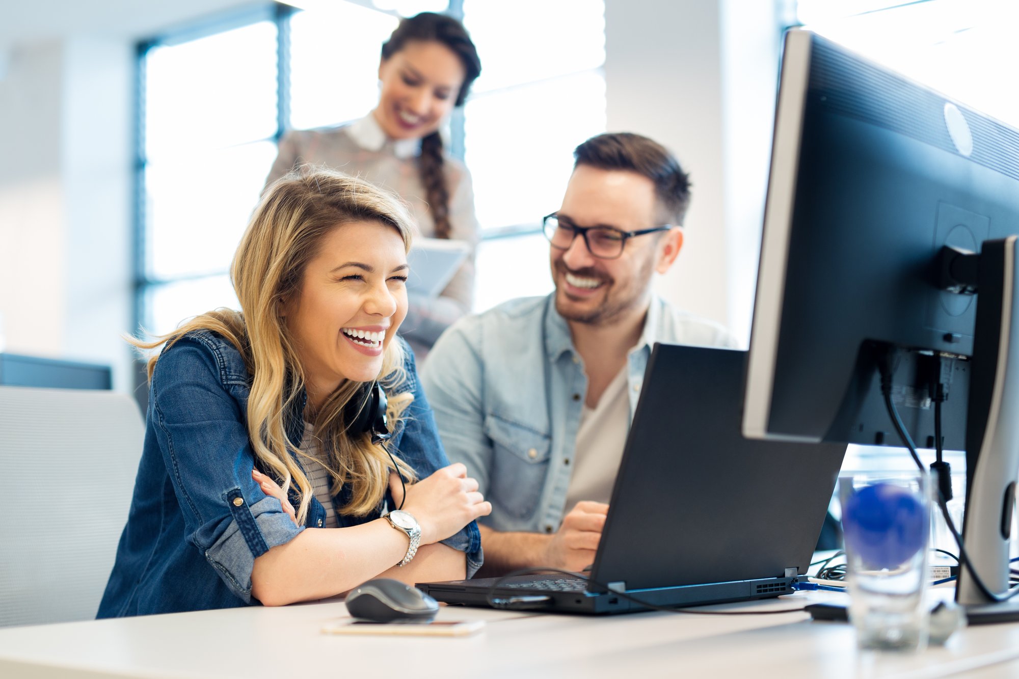 People looking at computer laughing