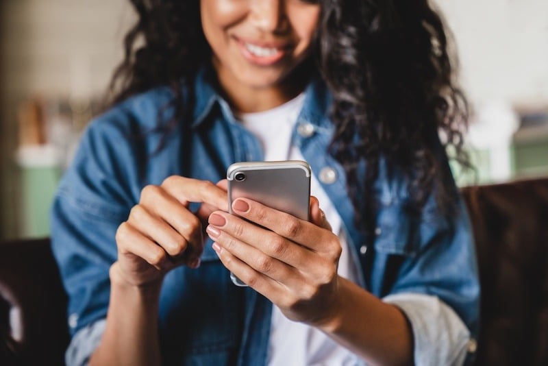 woman using phone for appointment reminders