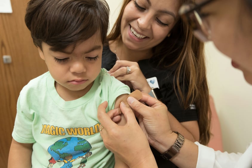 Woman giving a Child an Immunization