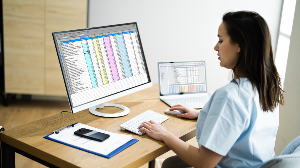 woman sitting at desk on computer using EHR